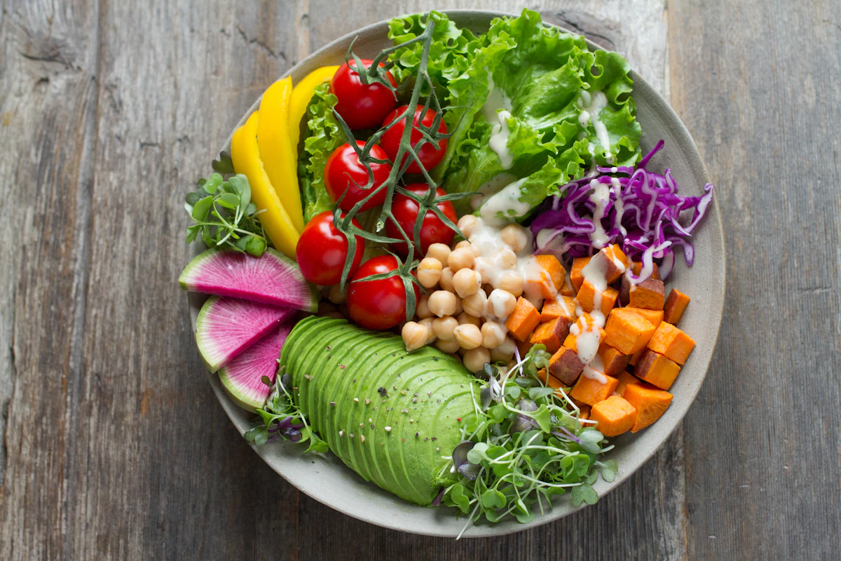 A colorful bowl of vegetables and other salad ingredients.